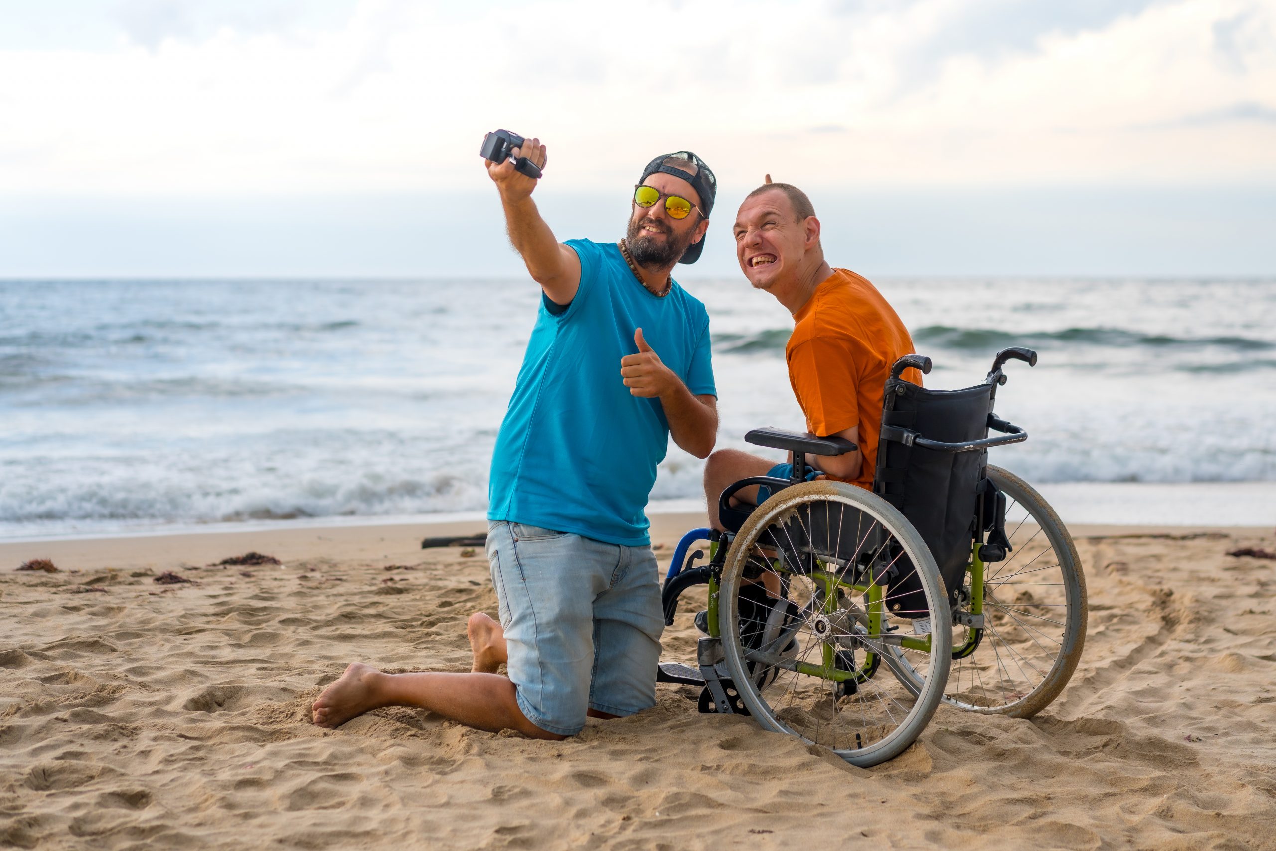 NDIS participant with support worker at a holiday accommodation by the sea