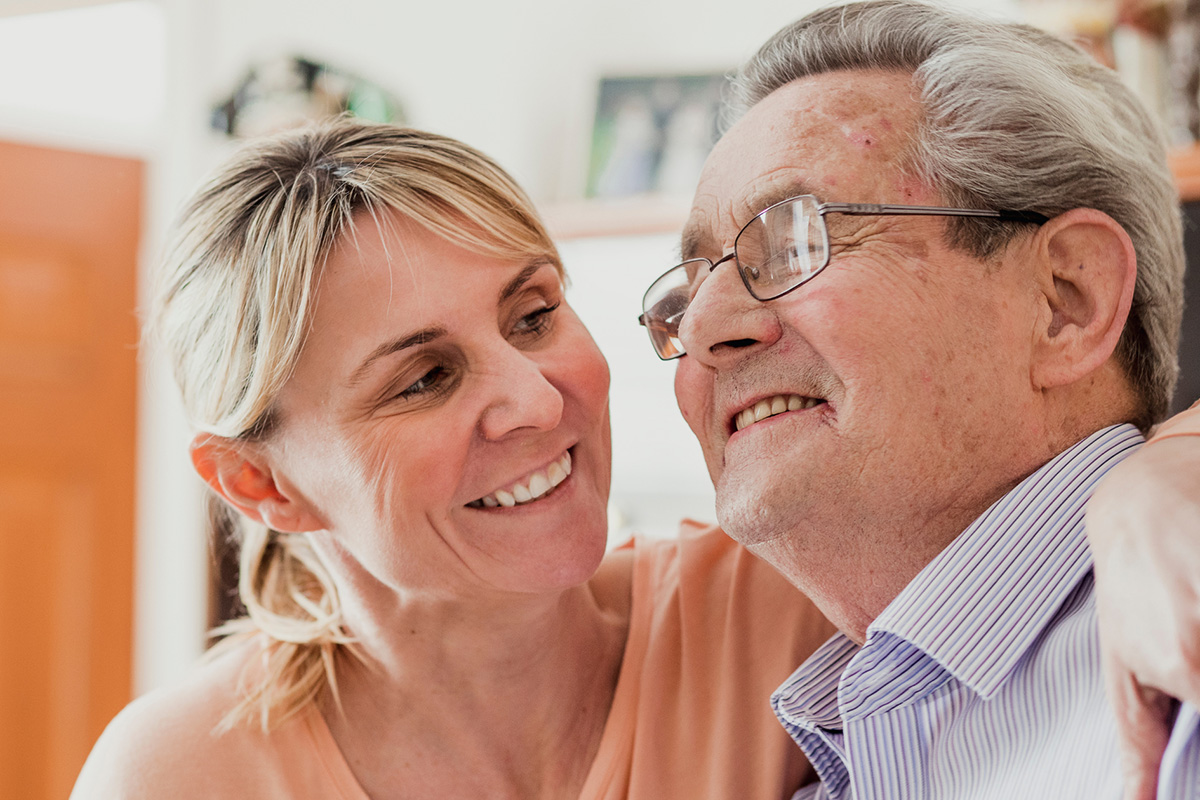 Disability care support worker assisting participant with daily living activities in Brisbane.